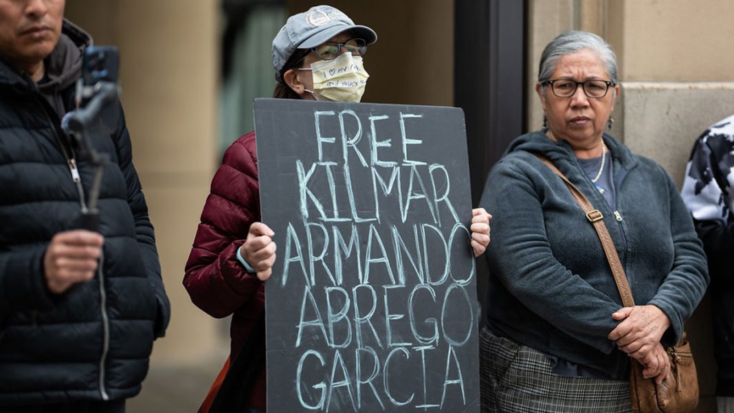 A protester holds a sign that reads 